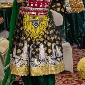 Traditional Embroidered Dress with Gold and Red Accents